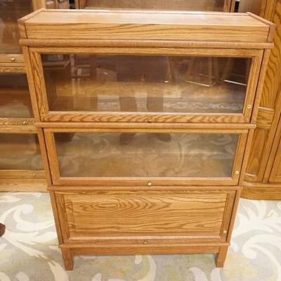 1176	SOLID OAK 3 SECTION BARRISTER BOOKCASE ONE BLIND DOOR. 34 IN WIDE, 11 IN DEEP, 49 IN H 

