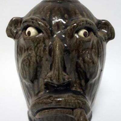 1153	JEFF HANDLING GROTESQUE FACE JUG, UGLY FACE JUG, MAN SMOKING A CIGAR WITH A TOBACCO SPIT GLAZE. GILETTE, GA, 11 IN HIGH, SIGNED AND...