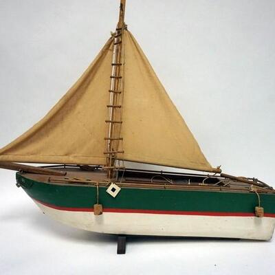 1038	VINTAGE PAINTED WOOD MODEL SAIL BOAT WITH CANVAS SAILS, 31 IN LONG X 29 IN HIGH
