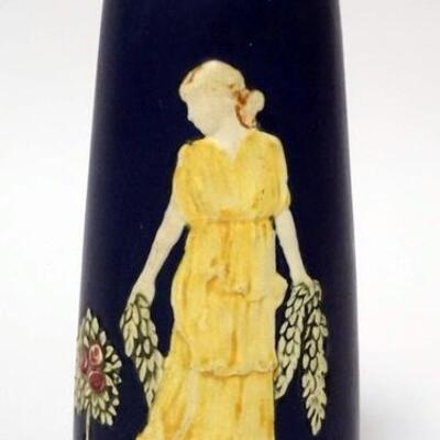 1100	UNSIGNED WELLER ART POTTERY VASE FEATURING A WOMEN HOLDING A GARLAND OF FLOWERS. 7 3/4 IN H 
