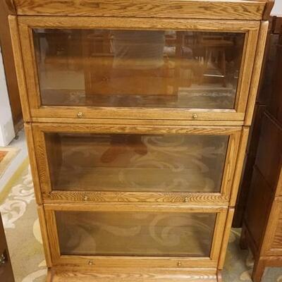 1178	OAK 3 SECTION BARRISTER BOOKCASE HAS PANELED SIDES & BEVELED GLASS DOORS. 36 IN W, 12 IN DEEP, 54 IN H 
