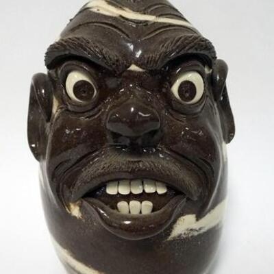 1160	MICHELLE PERDUE GROTESQUE FACE JUG, SWIRL FACE JUG, BROWN BASE WITH CREAM SWIRLS, SIGNED ON BOTTOM, 11 IN HIGH, LULA GA
