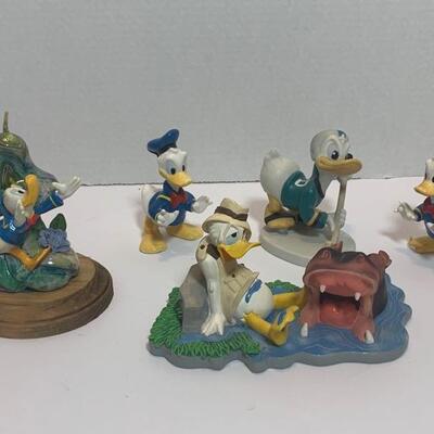 This is a collection of Donald Duck figurines and ceramic pieces. They are all in good shape with minimal signs of wear. Largest : 7x4x4...