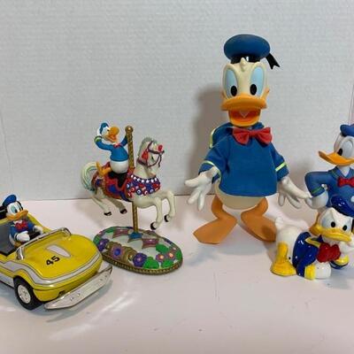 This is a collection of Donald Duck ceramics and figures by Disney. One of the figures has some chipped paint but over all they are in...