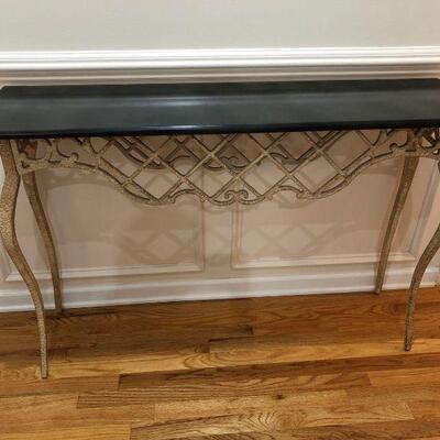 A narrow entryway table with an antique-looking base and an ebony surface. Dimensions:47.5â€x11.5â€x33â€...