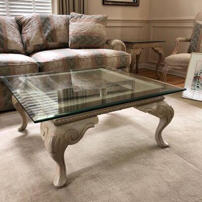 A beautiful square coffee table with glass top. Table is a whitewashed wood with gorgeous detailing on legs. This table coordinates...