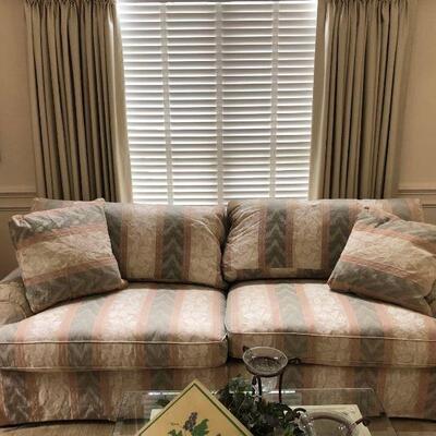 Very nice sofa with removable cushions and back pillows. It has a tan, light green, and pink design. Dimensions: 90â€x40â€x36â€ Seat...