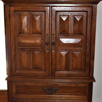 Wooden armoire has plenty and plenty of storage room all in a fashionably vintage cabinet.