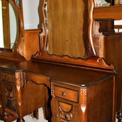 Antique vanity with large mirror is superbly crafted.
