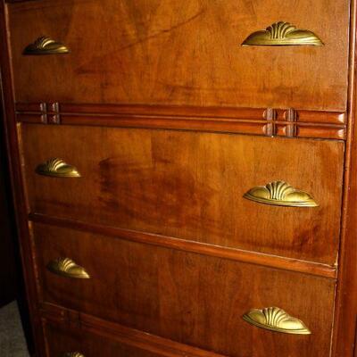 Antique Chest of Drawers features art deco style and drawer pulls.