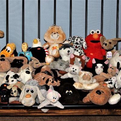 Large stuffed animal collection including Pound Puppies and other collectibles.