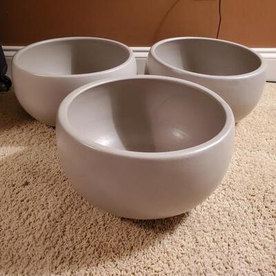 Set of 3 stoneware pots with cork bottom. All are in good condition and measure 12x7