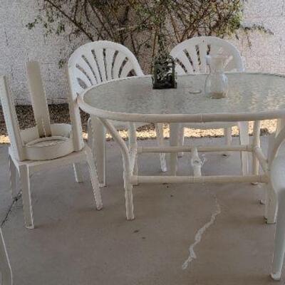 White patio table with 4 chairs and 2 stools