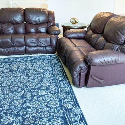 Pair of burgundy leather reclining loveseats