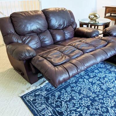 Burgundy leather loveseat shown in reclining position