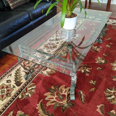 Glass top coffee table with wrought iron base.  Matches sofa table and end table