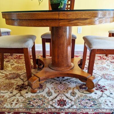 Showing pedestal and scrolled feet on oak table