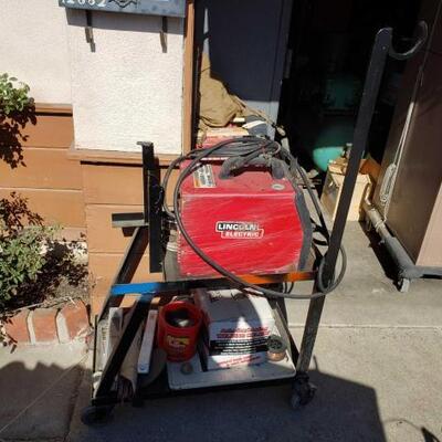 #1486 â€¢ Lincoln Electric SP-125 Plus Welder, Hood, And Cart measures approx 30 x x17 x 55.5 inches. 