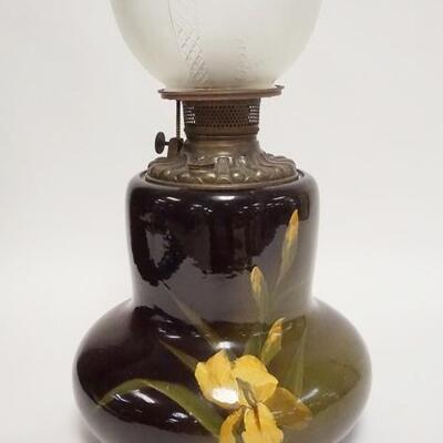 1043	LOUWELSA WELLER ART POTTERY KEROSENE LAMP, IRIS PATTERN, POTTERY PORTION IS 10 IN HIGH

