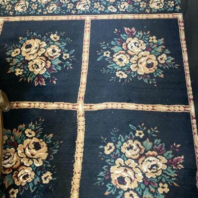 Floral rug with black background measures 7.5’ x 10.5’.  Priced at $75