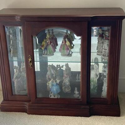 Small wooden display cabinet with one glass shelf.  Mirrored back.  Measures 35