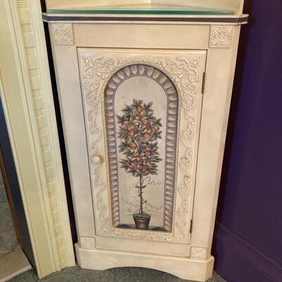 This painted corner cabinet is small in size and has a custom glass on top.  Priced at $95