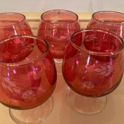 Set of five etched cranberry brandy glasses.  Priced at $55