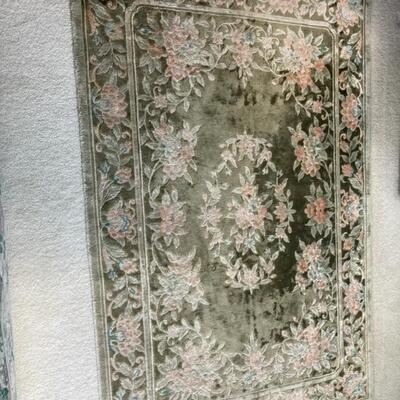 This green floral rug measures 4' x 6' Priced at $75