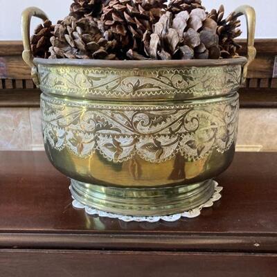 Beautiful Brass Bowl filled with Pinecones. Measures 11 1'2" wide by 7 1/2" tall