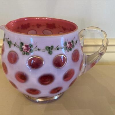 Cranberry coin dot pitcher with floral trim.  Priced at $75