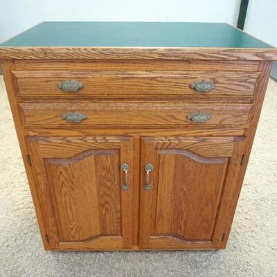 1052	2 DOOR 2 DRAWER CHEST HAS A GREEN FORMICA TOP. 39 IN W 45 IN H 25 IN DEEP

