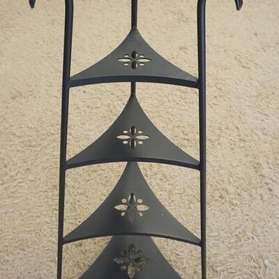 1085	TRIANGULAR IRON FOUR TIER SHELF, 41 IN H, THE SHELVES HAVE FLOWER CUT OUTS.
