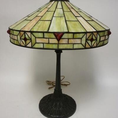 1002	ANTIQUE STAINED GLASS TABLE LAMP, HAS RAISED RED JEWELS ON THE BORDER. 23 IN H APP. 8 IN DIAMETER 
