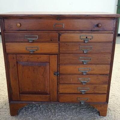 1055	COUNTRY STORE CABINET W/ NINE DRAWERS & ONE DOOR. HAS A FALL FRONT TOP SLOT. 40 IN W 39 IN H 15 IN DEEP
