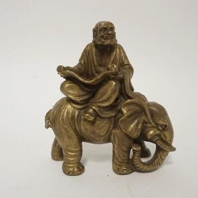 1258	SMALL BRONZE ASIAN MAN READING A SCROLL ON AN ELEPHANT, 4 1/2 IN H 
