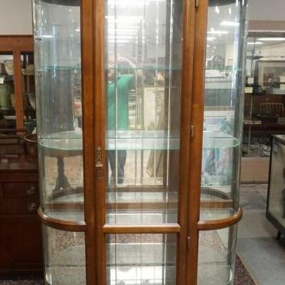 1083	CURVED GLASS CHINA CABINET HAS A CUT FRONT PANEL, MIRROR BACK , GLASS SHELVES, & ARCH TOP, 87 IN H, 61 IN W, 14 IN DEEP
