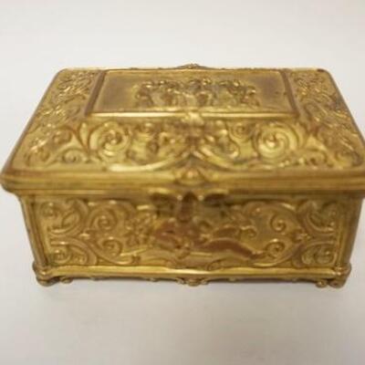 1143	BRASS FRENCH SILK LINED BOX HIGHLY EMBOSSED W/ CHERUBS, 4 IN X 3 IN X 1 3/4 IN H 
