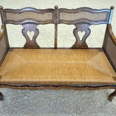 1080	CARVED & CANED RUSH BOTTOM LOVE SEAT, HAS A CUSHION. 47 IN W 
