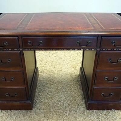 1073	MAHOGANY KNEEHOLE DESK W/ RED LEATHER TOP, HAS 8 DRAWERS ONE IS DEEP. 45 IN W, 23 IN DEEP, 32 IN H
