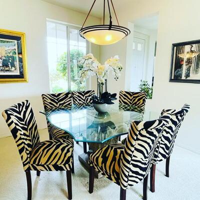 Zebra print dining chairs and glass top table