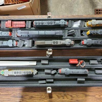 #1036 • Case with 10 HO Scale Locomotives and 2 Cabooses