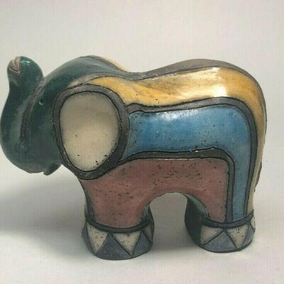 https://www.ebay.com/itm/114889015060	ME7001 South African Raku Pottery Elephant Figurine (dark green head)
