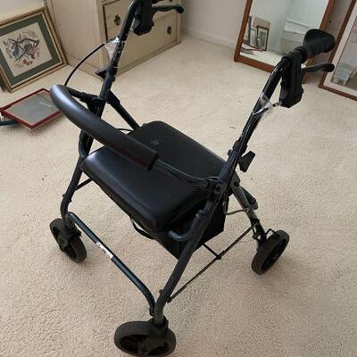 ROLLING WALKER WITH SEAT. SEAT HAS MINOR TEAR. BUY IT NOW $30