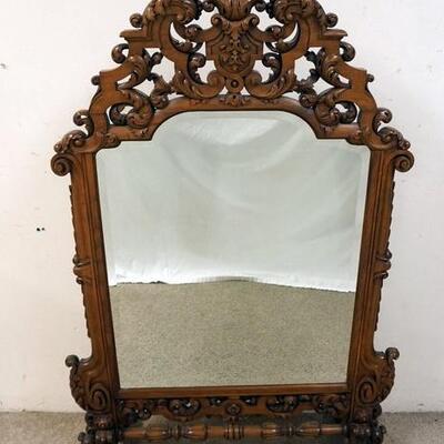 1143	ORNATE HIGHLY CARVED FREE STANDING BEVELED MIRROR. 58 IN HIGH X 37 IN WIDE
