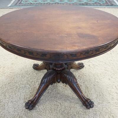 1003	OVAL WALNUT VICTORIAN CLAW FOOT LAMP TABLE W/ LEAF & VINE CARVED SKIRT 36 IN X 30 1/2 IN X 27 1/2 IN H 
