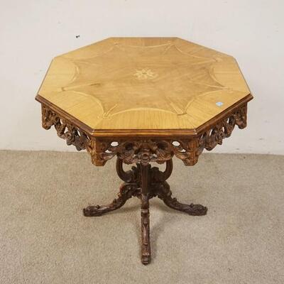 1090	INLAID OCTAGONAL TABLE W/OPEN CARVED SKIRT, HAS OPEN CARVED PEDESTAL, TOP IS 29 IN ACROSS, 29 1/4 IN HIGH
