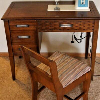 Singer sewing machine with chair and console.