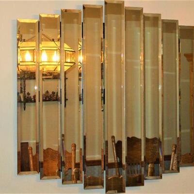 Mid-century mirror features nine beveled panels in multi-dimensional layers.  Adds a splash of design to any home.