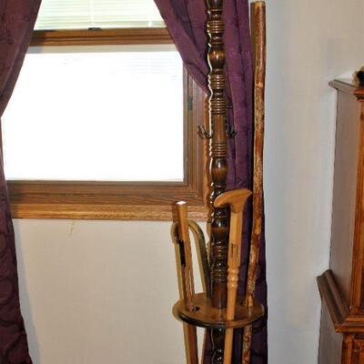 Coat stand with collectible canes and walking stick.