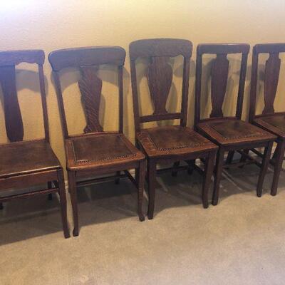 5 antique miscellaneous oak chairs with leather seats. 1 needs repair.